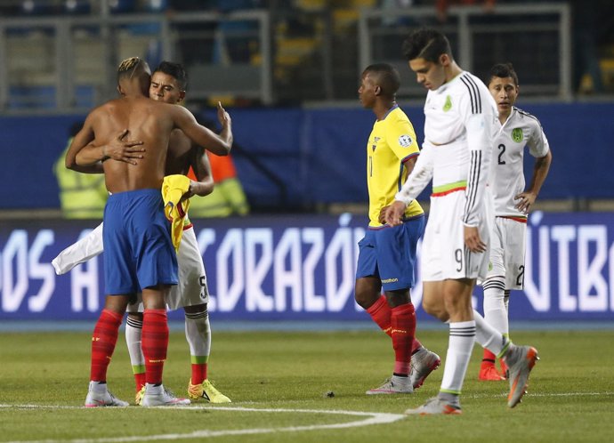 Mexico's Medina and Ecuador's Martinez embrace while exchanging jerseys after th