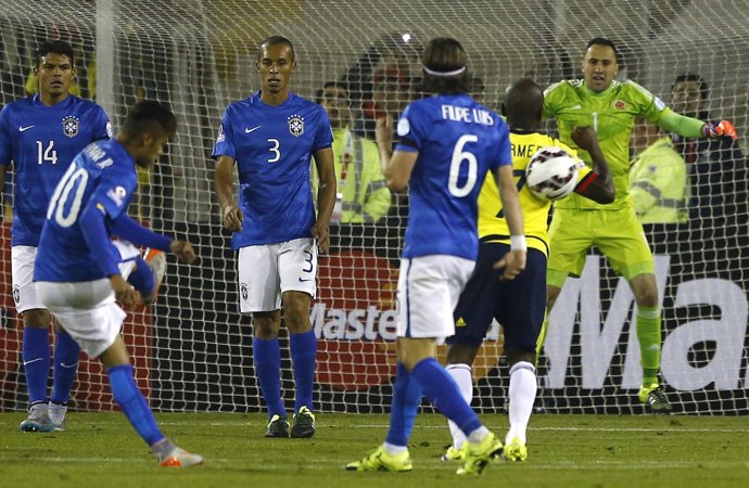 Brazil's Neymar kicks the ball into Colombia's Armero after the referee finished