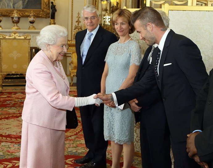 Queen Elizabeth II meets David Beckham at a reception at Buckingham Palace to ce