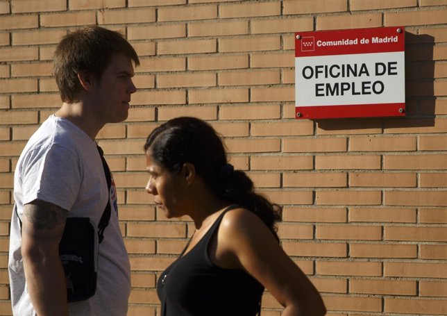 People stand in front of a government-run employment office in Madrid