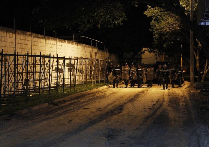 Police walk outside the Renacer juvenile detention center in Tamara