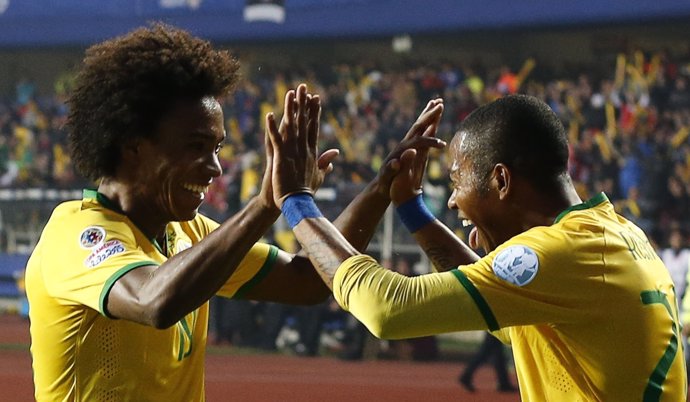Brazil's Robinho celebrates his goal against Paraguay with teammate Willian duri
