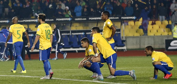 Brazil's players react after losing their penalty shootout to Paraguay in their 