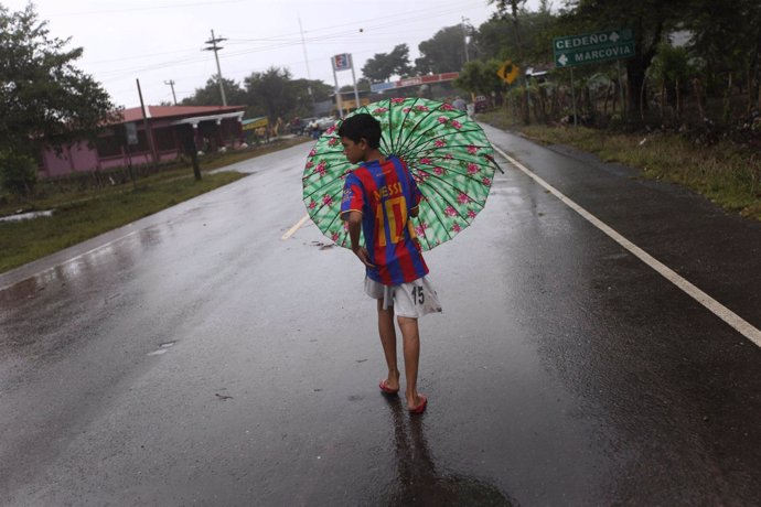 A child walk through a street after heavy rain in Marcovia