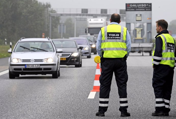 Danish customs officers watch traffic at a checkpoint on the German-Danish borde