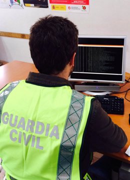 Un agente de la Guardia Civil analiza uno de los ordenadores intervenidos