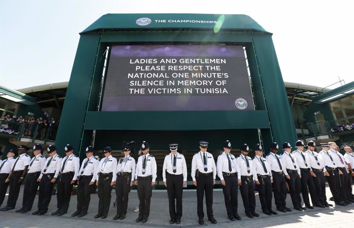 Police officers observe a national minute's silence for victim's of the attacks 