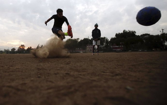 Youths play soccer in Santiago, Chile