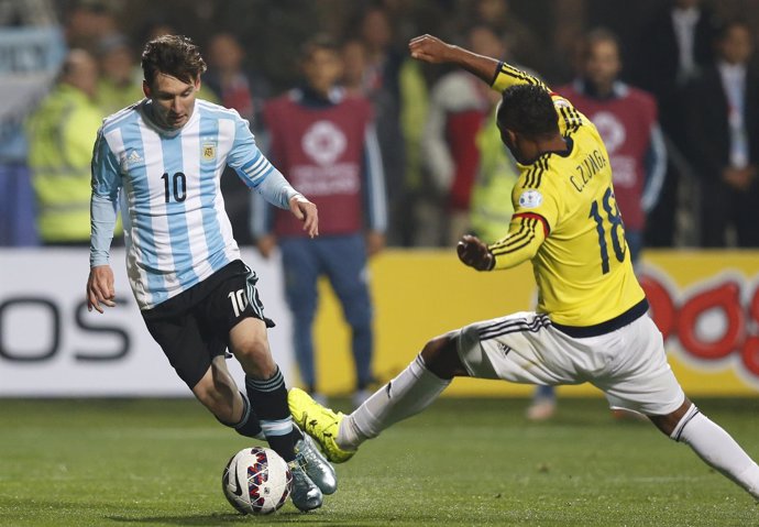 Argentina's Messi controls the ball next to Colombia's Zuniga during their Copa 