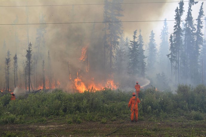 Firefighters tackle a wildfire near the town of La Ronge