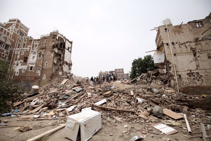 Civil defence workers and people search for survivors under the rubble of houses