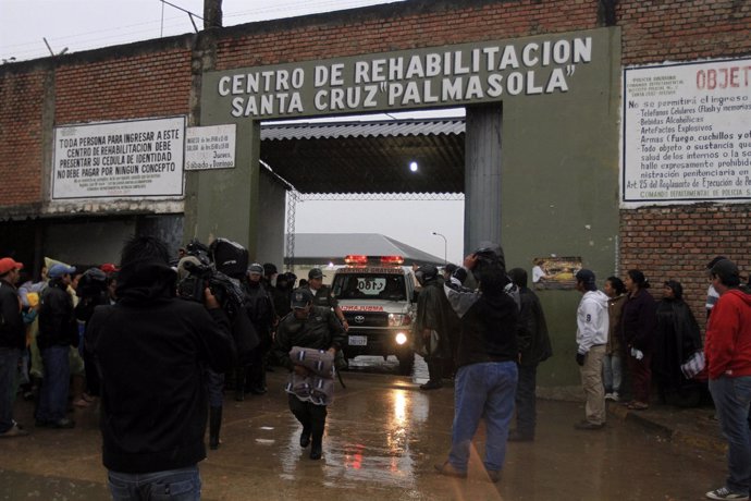 Relatives of inmates wait for news at the entrance of Palmasola Penitentiary Com