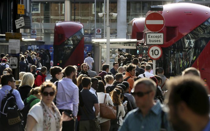 Commuters wait for buses at Victoria Station in London