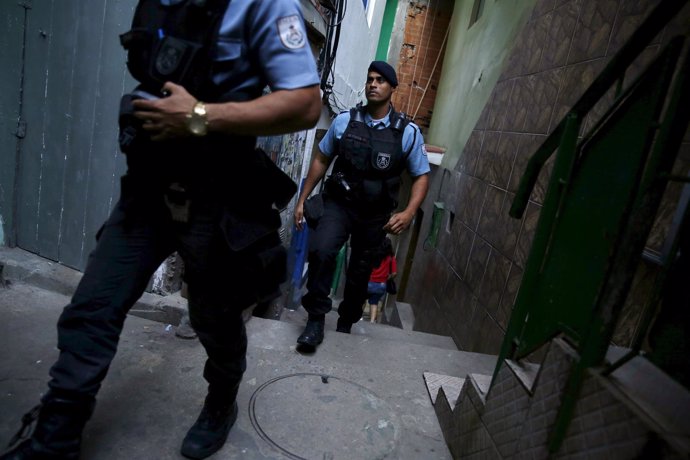 Police officers patrol at Santa Marta slum in Rio de Janeiro, Brazil
