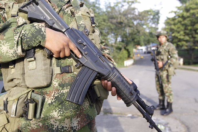 Colombian soldiers stand guard at a street in Caloto