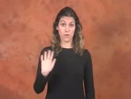 Mujer diciendo 'hola' en lenguaje de signos español