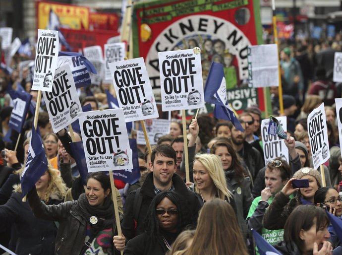 Teachers hold placards and banners during a march in central London