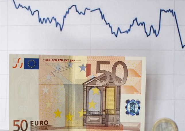 Euro banknote coin and a currency graph are placed on mirror and in this picture