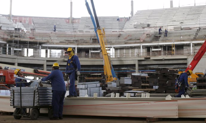 Workers are pictured at the basketball venue at the Rio 2016 Olympic Park in Rio