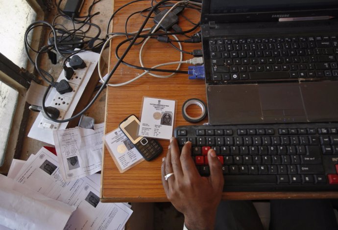 An operator works on his table while enrolling villagers for the Unique Identifi