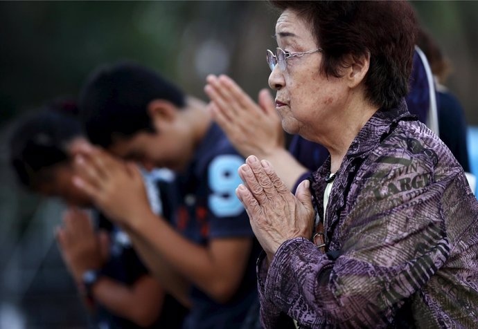 People pray for the atomic bomb victims in front of the cenotaph for the victims