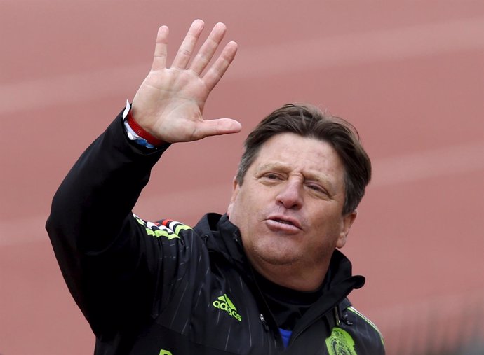 Mexico's head coach Miguel Herrera waves to the media after attending a training