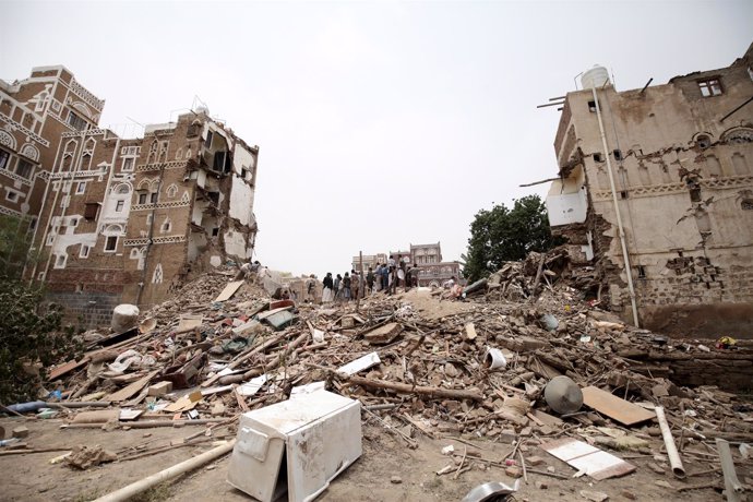 Civil defence workers and people search for survivors