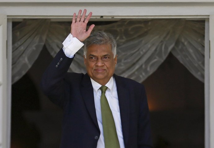 Wickremesinghe, leader of Sri Lanka's United National Party, waves at the Prime 