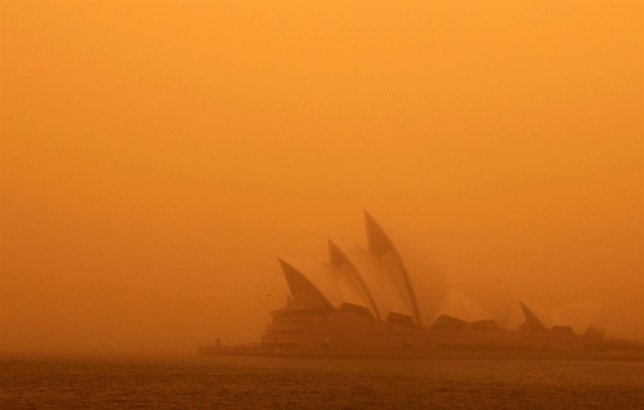 A dust storm blankets Sydney's iconic Opera House at sunrise