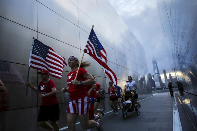 Members of the Red White and Blue team run through the 9/11 Empty Sky memorial a