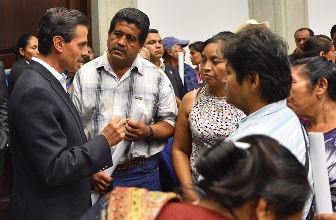 Handout photo of Mexico's President Pena Nieto talking to relatives of the 43 mi