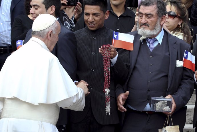 Pope Francis greets a group of miners from Chile as he leads the weekly audience