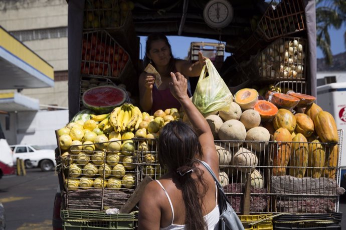 Fernanda Bolivar buys vegetables from a street vendor close to the Mother Teresa