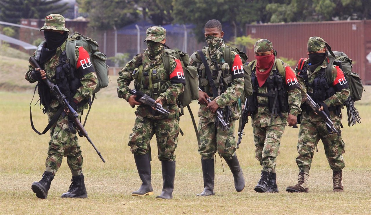 Defected members of Colombian guerrilla group ELN walk to a military base to sur