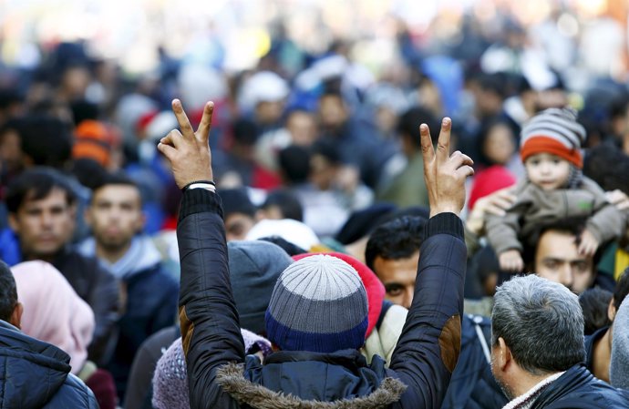 Un refugiado hace el gesto de la victoria tras llegar a Alemania