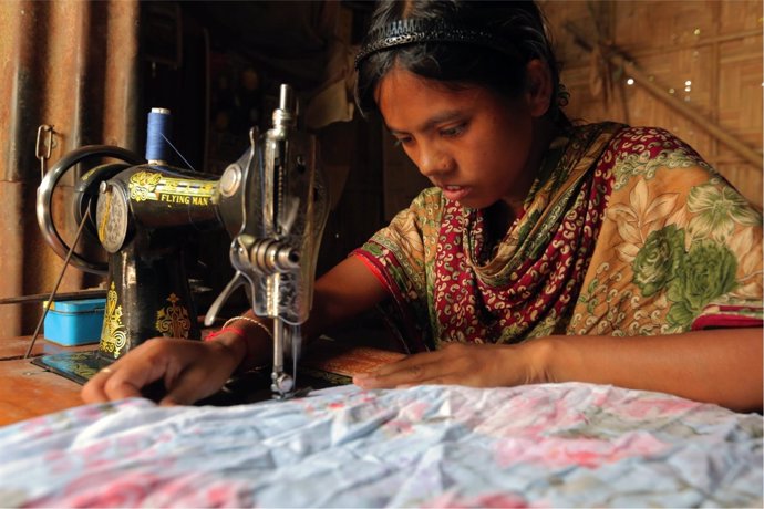 Una niña de Bangladesh cose para ayudar económicamente a su familia