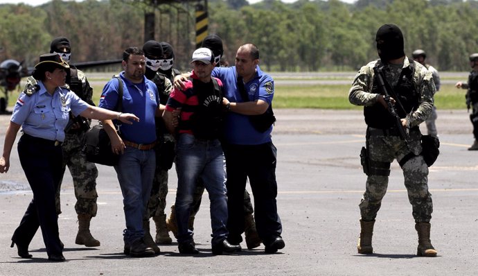 Former Paraguayan Mayor Vilmar Acosta is being escorted by soldiers and members 