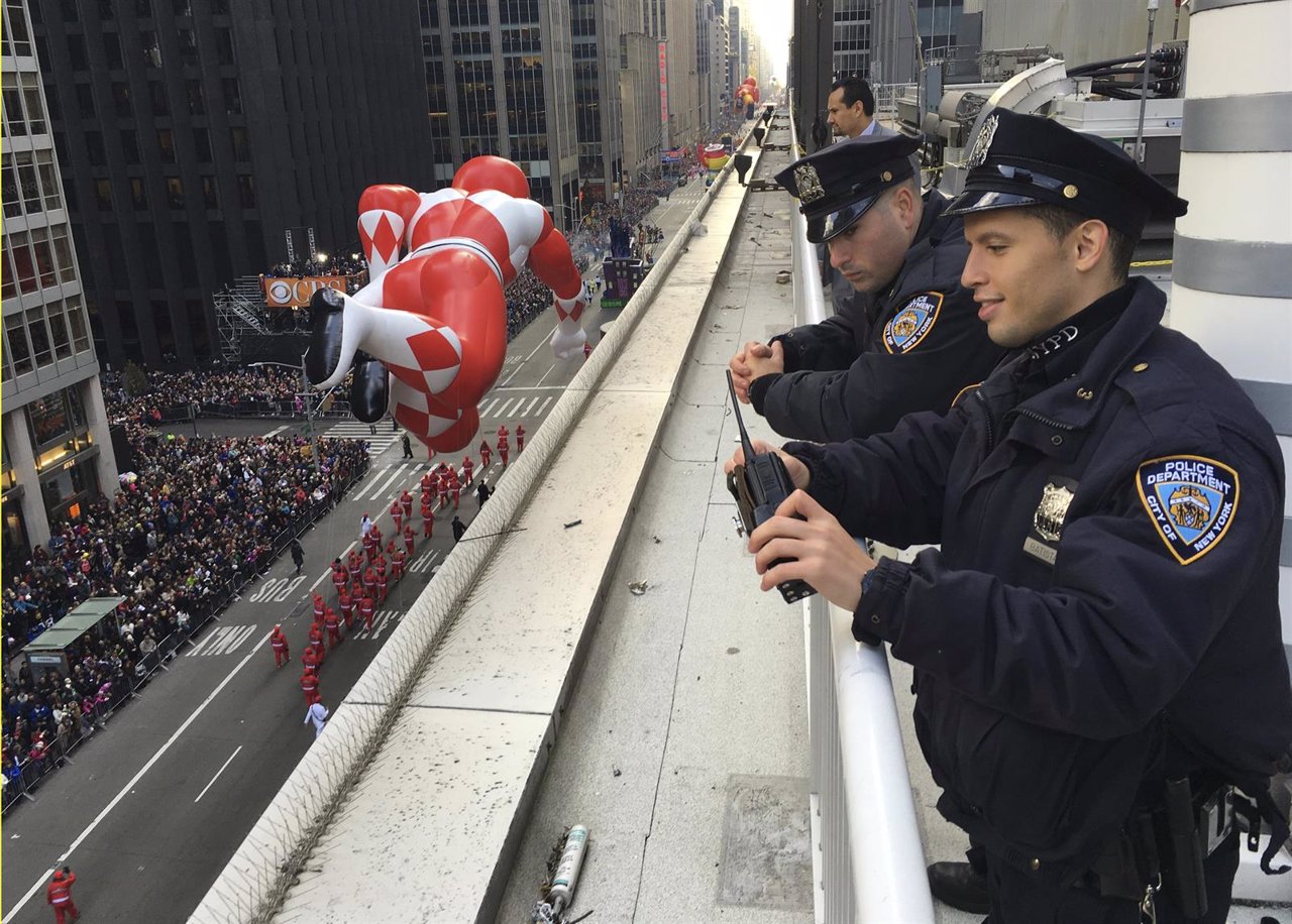 New York Police Department officers survey 6th Ave during the 89th Macy's Thanks