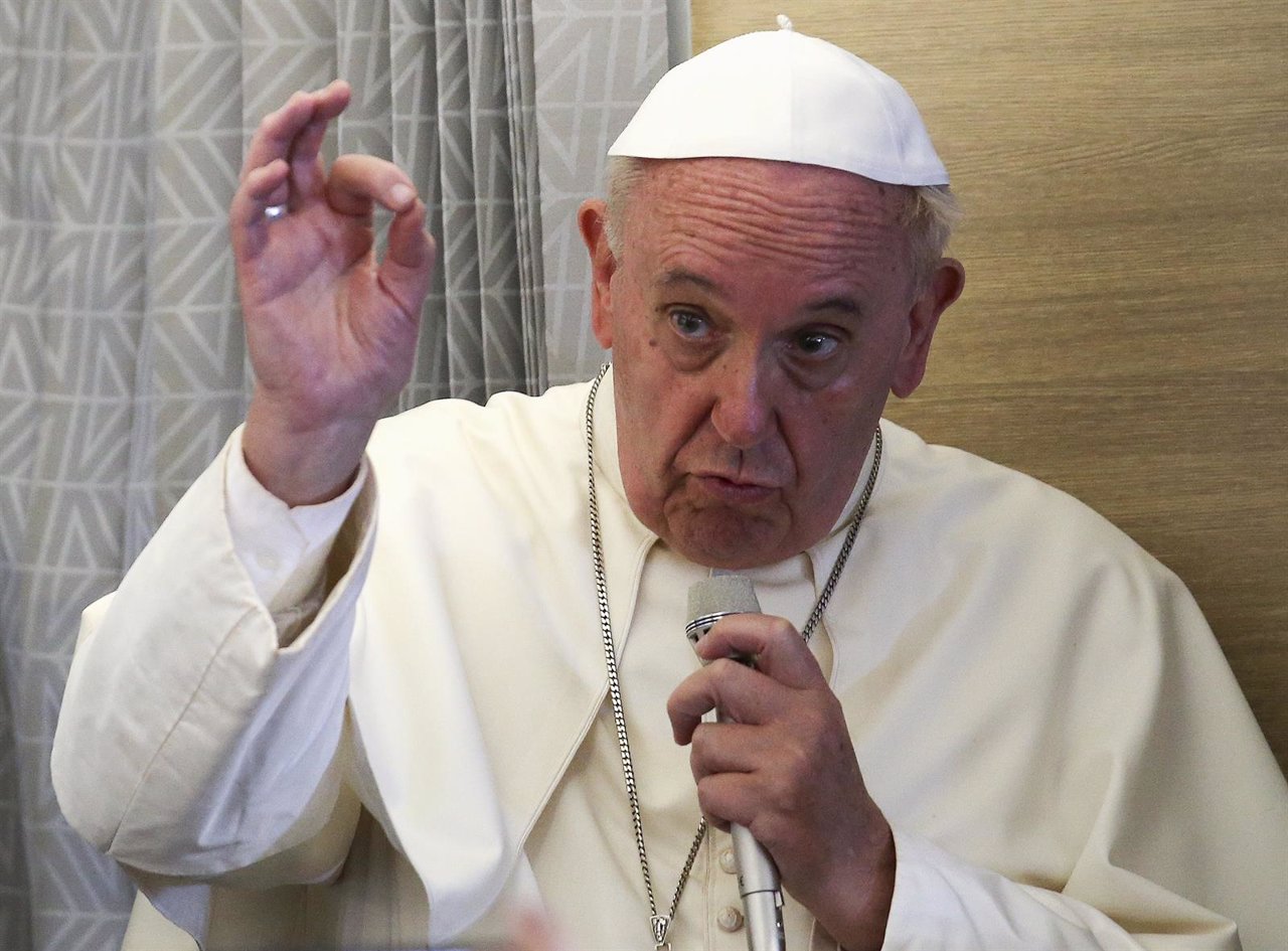 Pope Francis gestures during media's meeting aboard the papal plane while en rou