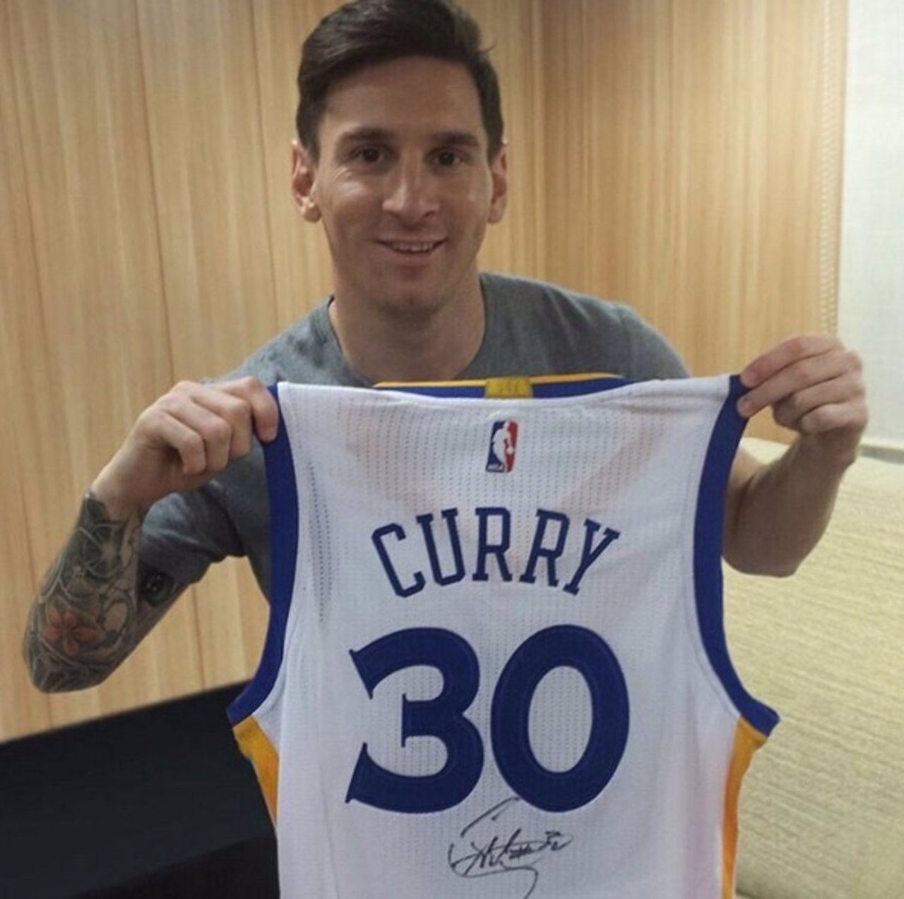 Messi posa con la camiseta regalada por Stephen Curry