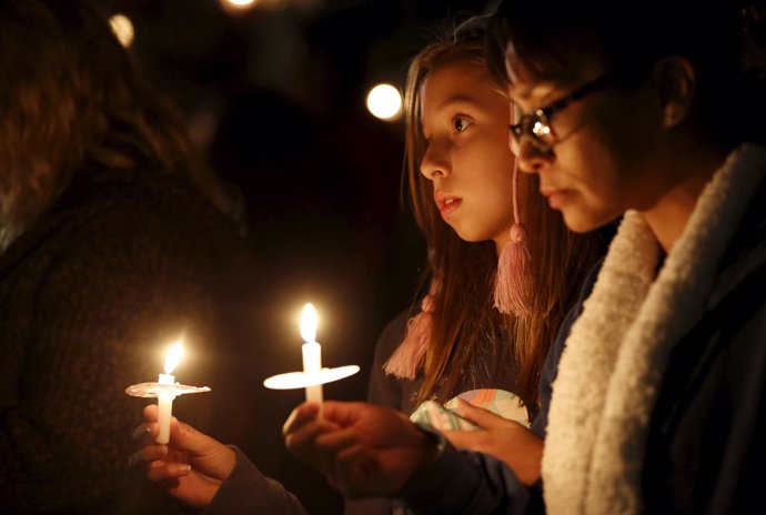 Attendees reflect on the tragedy of Wednesday's attack during a candlelight vigi