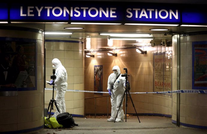 Emergency responders investigate a crime scene at Leytonstone underground statio