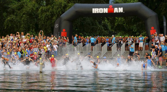 Athletes compete in the waters of Lake Zurich at the start of the swimming leg o