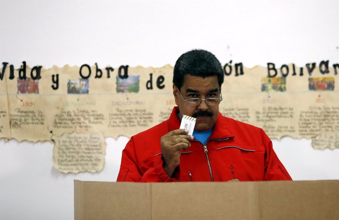 Venezuela's President Nicolas Maduro shows his ballot before casting his vote at