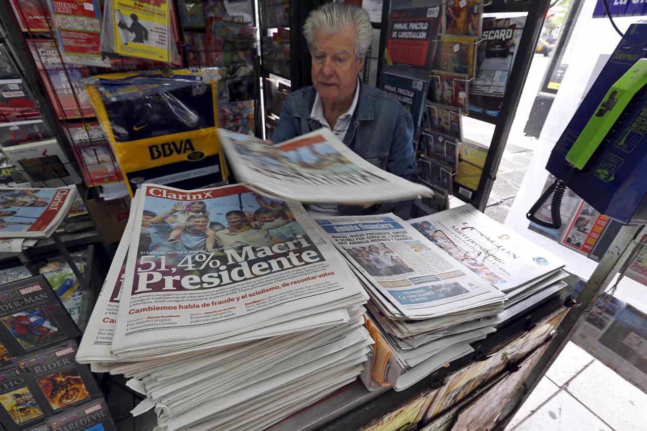 A man sells newspapers printed with the frontpage image of Argentina's president