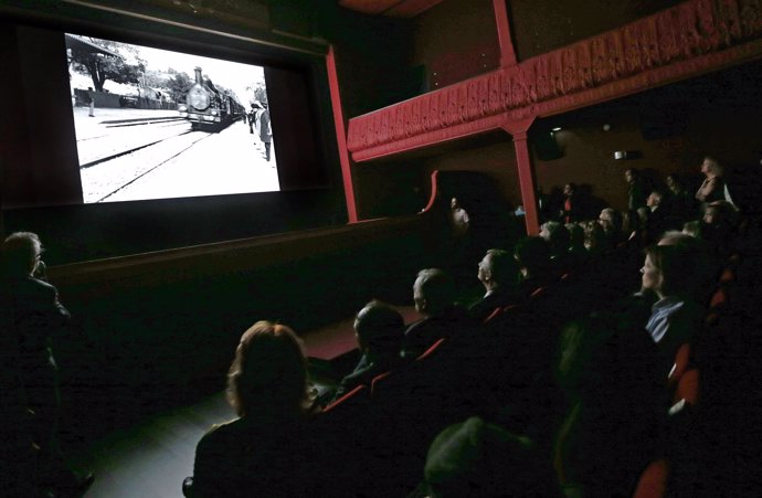 People watch one of the very first projected movies "L'arrivee d'un train en gar