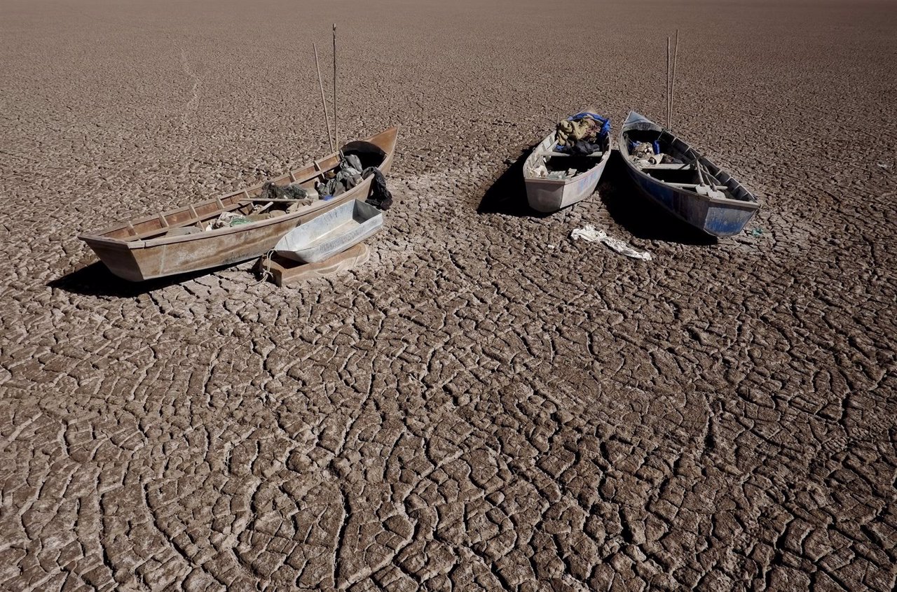 Boats of fishermen are seen on the dried Poopo lakebed in the Oruro Department, 