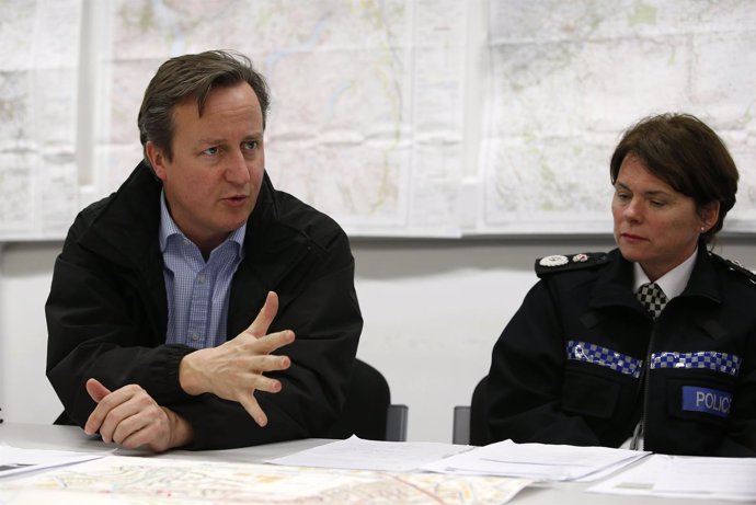 Britain's Prime Minister David Cameron (C) attends a meeting of flood rescue ser