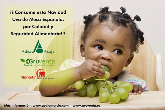 Baby girl eating grapes