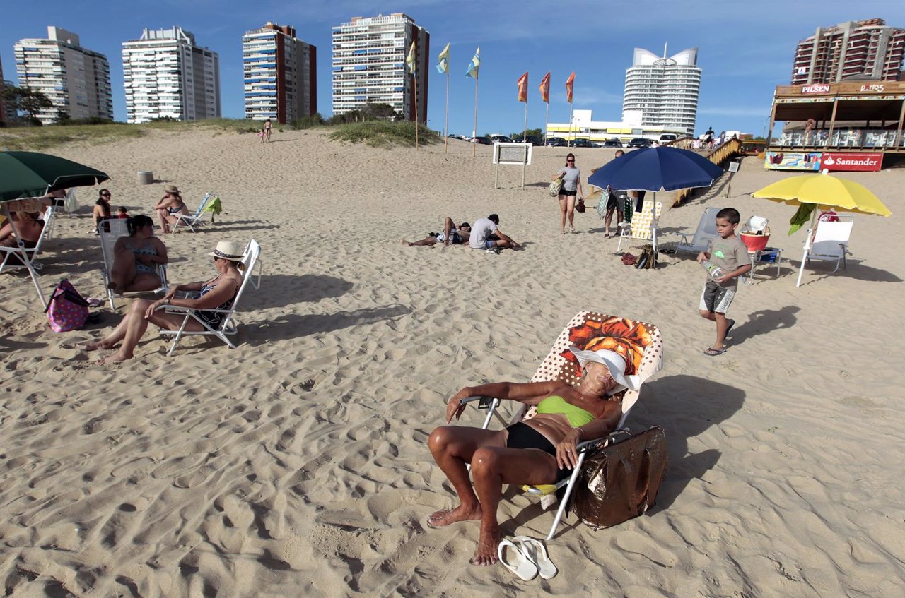 People sunbathe at the beach of the luxurious seaside resort of Punta del Este